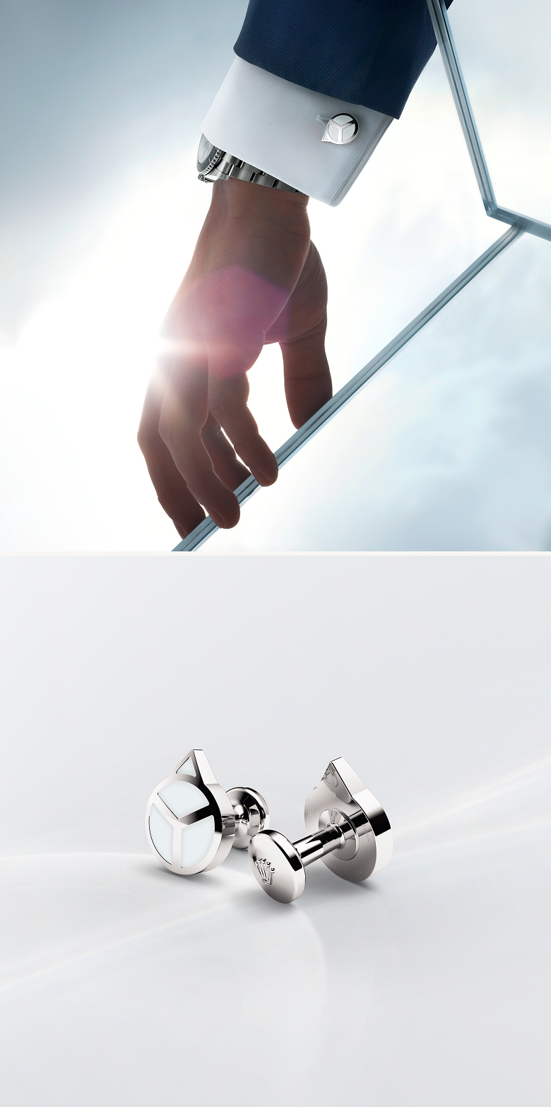 A photo of a two hand cufflinks and an arm wearing the hand cufflink
