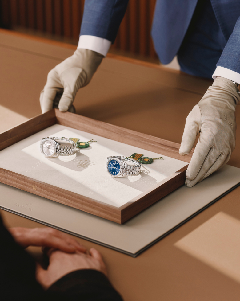 Women looking at a watch being serviced